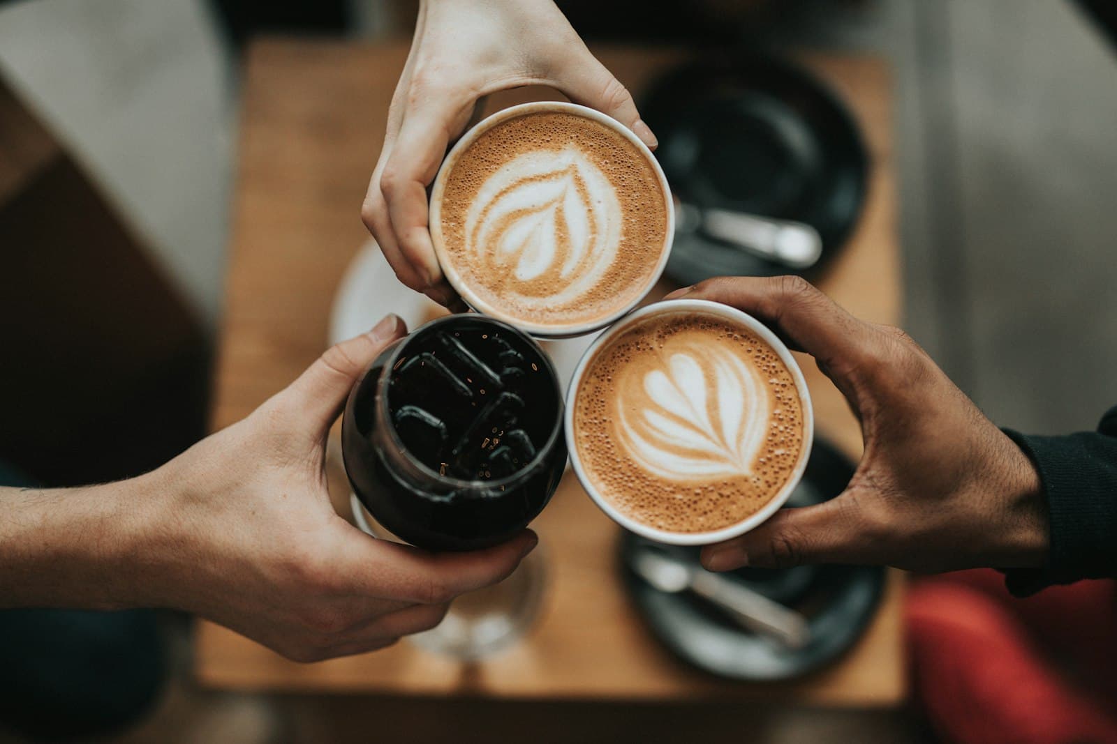 Latte art in a ceramic cup held in both hands